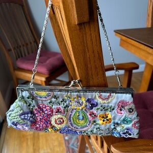 Small Bandolino frabric clutch with beautiful beading and shoulder strap.